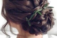 49 a wavy low bun with a wavy top and a wavy bun, with some locks down and a greenery touch is a chic and lovely idea