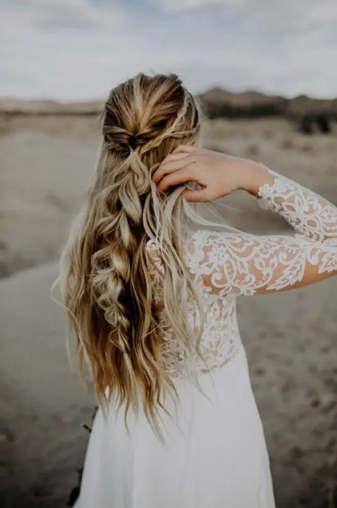 A boho half updo with braids and twists, with a large bubble braid and waves down is a beautiful and eye catchy option