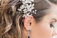 51 short curly wedding hair with side parting and a large and beautiful crystal hairpiece is a very refined and chic idea for a wedding
