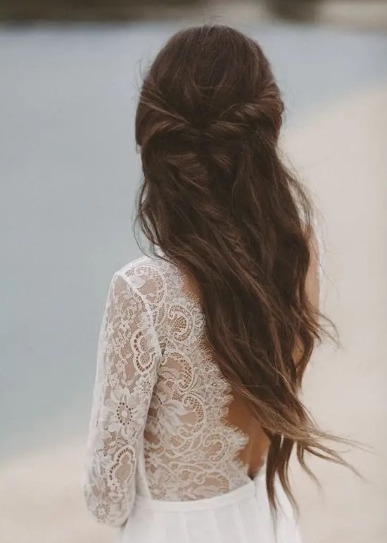 a beautiful half updo with a messy twisted braid and waves down will effortlessly finish off your bridal look