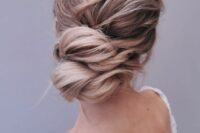 52 a lovely twisted low updo with a wavy and messy top is a good idea for long hair, you can keep it all up