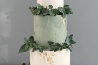 53 a stylish wedding cake with white and sage green tiers, gold leaf and greenery is amazing for many weddings