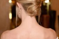 54 a low French twisted updo with a volume on top and locks down is a stylish idea for a effortlessly chic bride