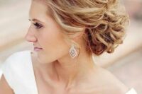 54 an airy and breezy wavy updo with curls and volume on top for an elegant feel