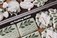 55 an assortment of beautiful green and white cookies is ideal for a sage and white wedding
