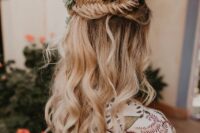 56 a beautiful boho wedding hairstyle with a fishtail braid halo, waves down and bold blooms and pale leaves tucked in