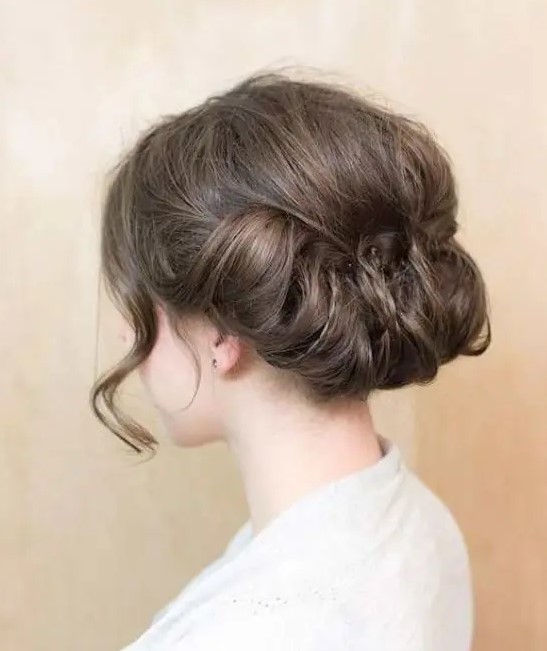 A low updo with a bump and a twisted bottom plus some locks down looks very refined and vintage inspired
