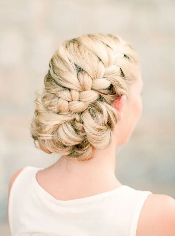 a voluminous side braided updo with twisted parts and no accessories is a safe idea that will last long