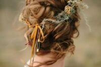58 a messy and twisted updo with a volume on top and some locks down and a dried flower crown is a great solution for a fall boho bride