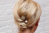 61 a simple twisted low updo with a messy top and a couple of rhinestone hair pins is idea for medium length hair