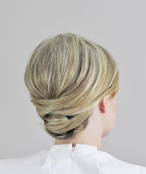 a sleek and twisted low updo with a bump on top is a stylish idea for medium length hair