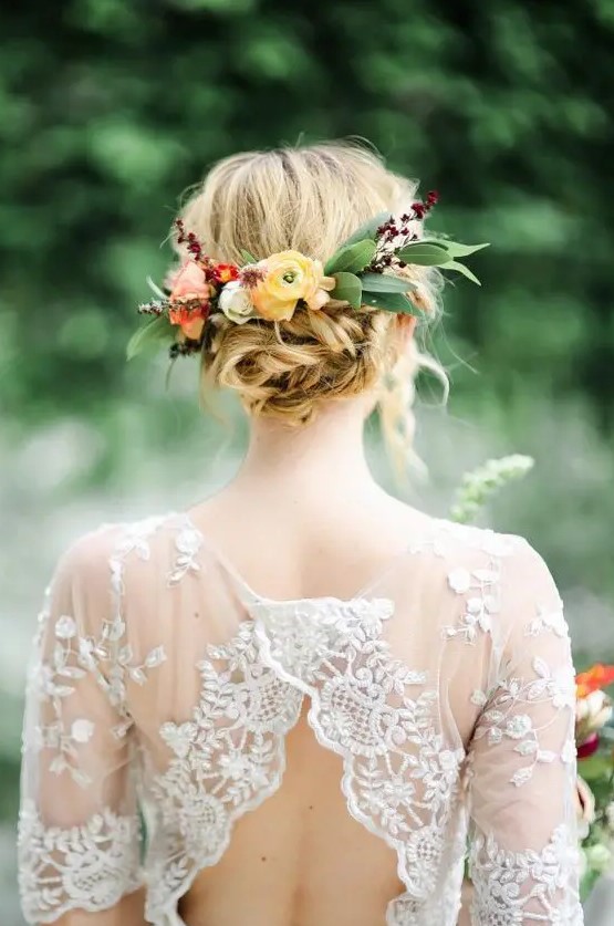 a twisted messy bridal updo topped with leaf and fall flower headpiece is a great idea for summer and fall weddings