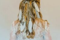 68 a half updo with a bump and waves spruced up with a lot of feathers is inspired by vikings and is ideal for a boho bride