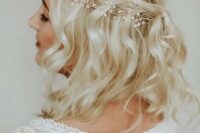 69 a half updo with a halo braid and waves accented with a hair vine for a boho bride