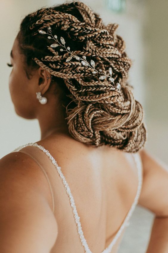 a fully braided low updo with a floral hair vine is a chic and cool idea for a wedding, it will catch all the eyes