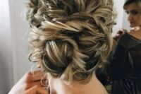 72 tie up your curly hair into a large twisted low bun, it will look very textural and messy, which is trendy