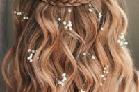 73 a lovely wedding half updo with a braided halo, waves down and some baby’s breath tucked into the hair is idea for summer