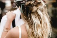 74 a messy textural half updo with twists and braids and greenery and feathers is ideal for a boho bride
