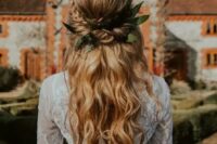 76 a romantic boho wedding hairstyle with a twisted and braided halo with a volume on top and waves plus leaves