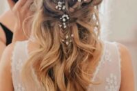 79 a twisted braided half updo with waves and baby’s breath tucked in