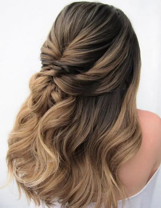 a beautiful dimensional wedding half updo with a bump on top and some waves down is a cool idea for a bride with long hair