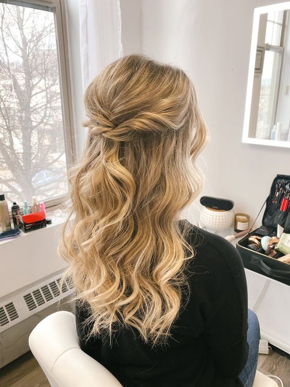 a beautiful golden blonde wavy half updo with a bump on top and some twists is a cool idea for a wedding