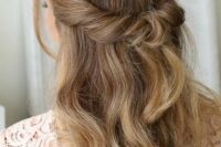 a beautiful looped half updo with waves down and face-framing locks is a cool idea for many brida styles