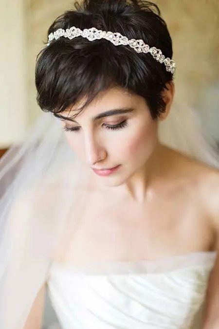 a black straight pixie haircut with a rhiestone headband is a stylish idea for a wedding, it looks chic and beautiful
