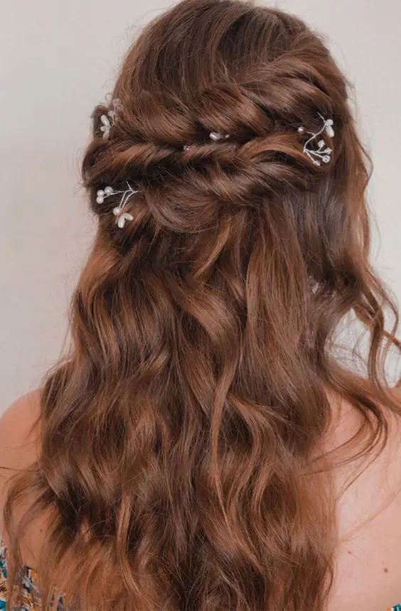 a brunette half updo with a twisted double halo and waves down, with pearl and rhinestone hair pins is chic and cool