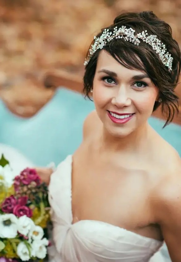 a chic wavy hairstyle with a rhinestone headband and a berry lip will make you stand out for sure