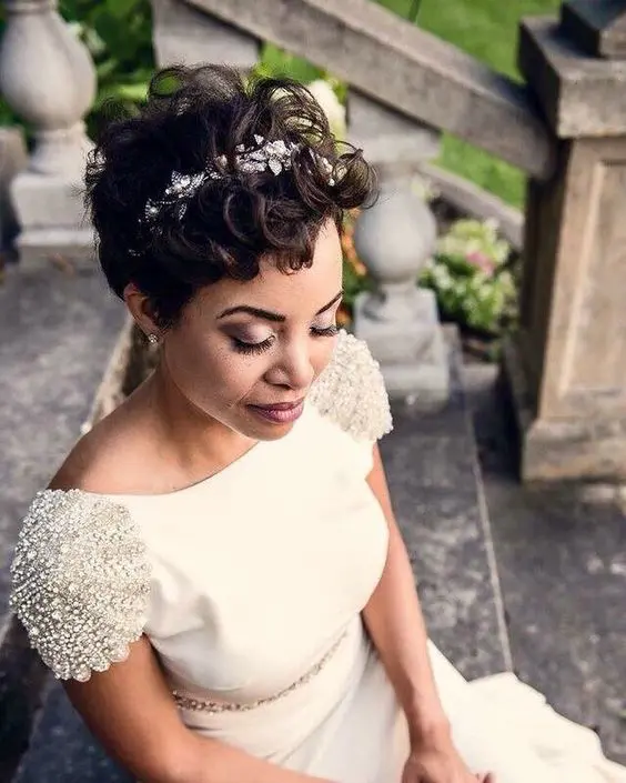 a dark brunette wavy pixie with a floral headband is a very chic and stylish idea for a wedding, it looks cool