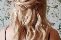 a delicate and relaxed blonde medium half updo with a bump on top, twists and waves down is cool