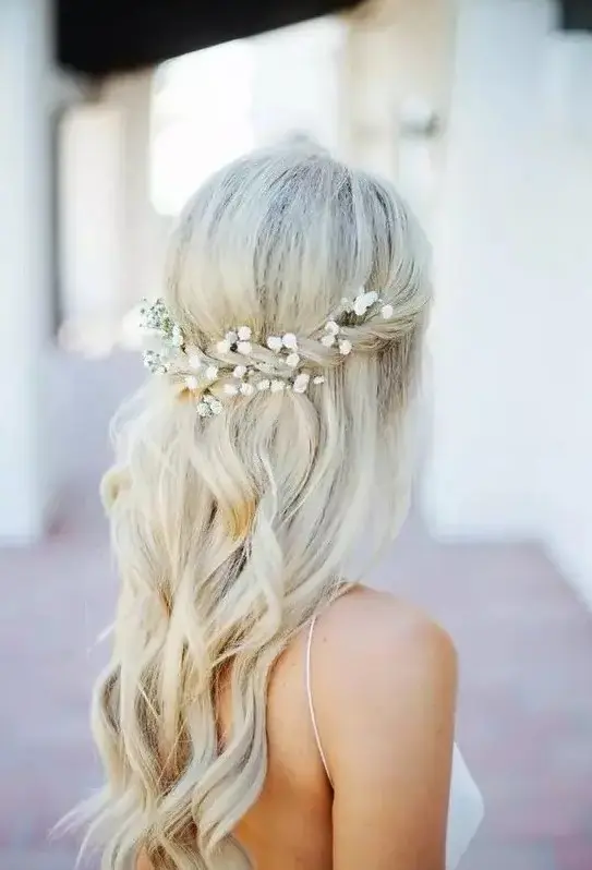 a half up with a twist and baby's breath in it, some waves for a romantic look at a boho beach wedding or some other boho wedding
