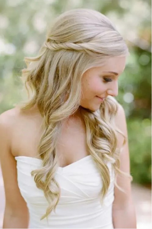 a half updo with a volume on top, a twisted halo and waves down is a romantic and timeless hairstyle