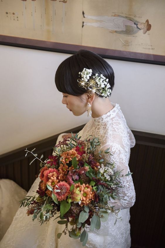 a long and straight dark brown pixie with fresh blooms is a catchy and stylish idea for a wedding