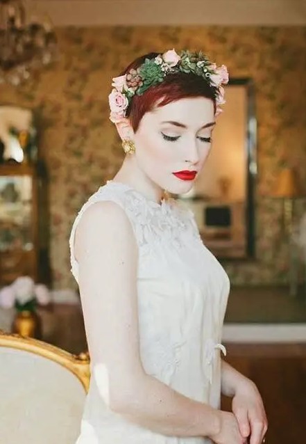 a pixie haircut with a fresh crown of pink roses, succulents and greenery for a romantic and sexy bride