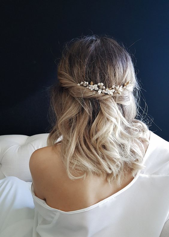a pretty textured wavy half updo with twists, waves down and an embellished floral headpiece is a cool idea for a wedding