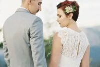 a short red hairstyle accentuated with a cute fresh flower and greenery hair pin to make the look romantic