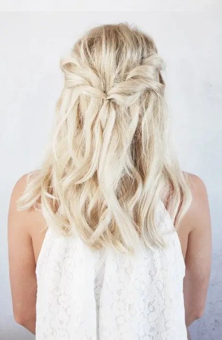a twisted half-up braid with beach waves is a chic idea for medium-length hair and if you don't need anything formal