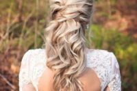 a twisted half up half down hairstyle with waves looks very romantic and beautiful