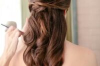 an elegant wedding half updo with a volume on top, some twists and waves down is a picture-perfect option