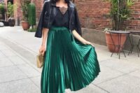 03 a black top with a lace neckline, a black cropped leather jacket, a green metallic pleated midi skirt, black heels