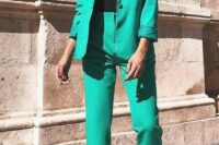03 a green pantsuit with an oversized blazer, silver heels and a black lace bodysuit for a refined and chic fall wedding