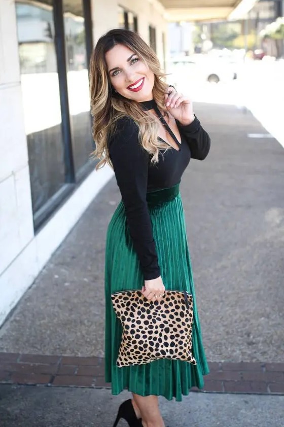 a cutout black top, an emerald pleated midi skirt, black shoes and a leopard clutch for a fall wedding