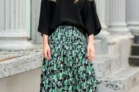 06 a fall wedding guest outfit with a black top with wide sleeves, a black green floral print midi skirt, pink shoes