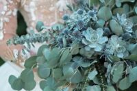 06 a pale green cascading wedding bouquet with eucalyptus, succulents and blue thistles for a fairy-tale feel