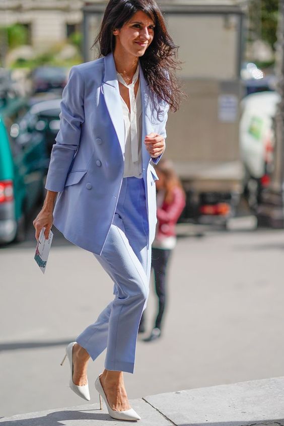 a periwinkle pantsuit,, a white shirt with a tie and white shoes are a lovely and stylish combo for a spring wedding