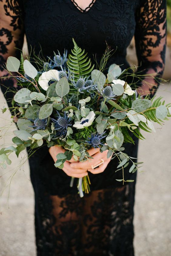 a pretty textural and dimensional wedding bouquet of greenery, fern, twigs and thistles plus white anemones is a cool idea