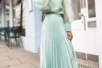 09 a mint green pleated midi skirt styled with a matching blouse with puff sleeves and floral slip mules