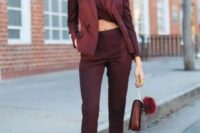 11 a total burgundy look with a twisted crop top, high waisted pants, a blazer, a bag, sheer shoes